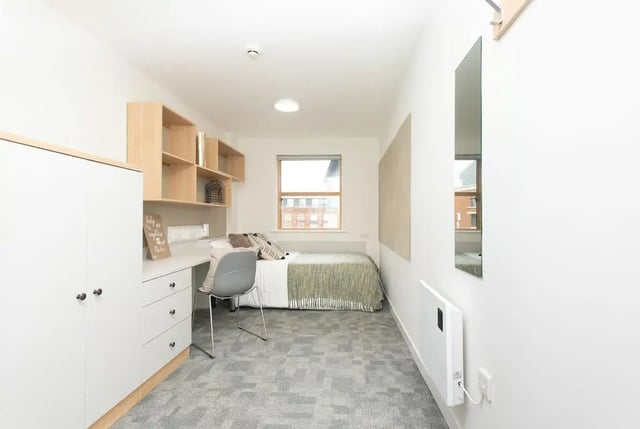 Bed desk shelves wardrobe chair and bed bedroom at Abode York in York Student Accommodation