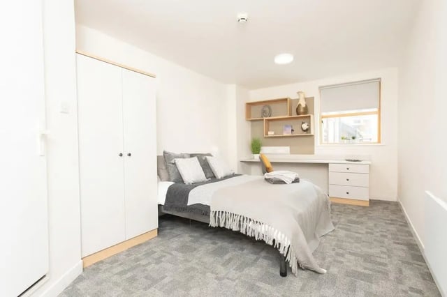 Bed wardrobe desk shelving window bedroom at Abode York in York Student Accommodation
