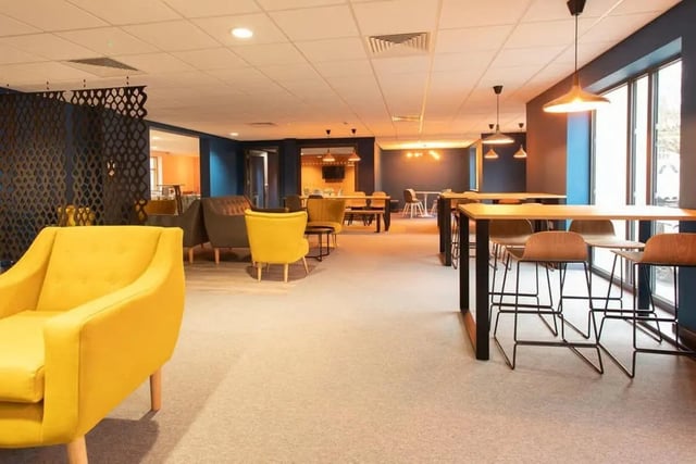 Yellow chairs tables and bar stools common area at Abode York in York Student Accommodation