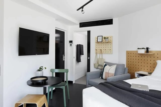 TV sofa bed bedside table studio apartment at UKO Paddington Village in Sydney Student Accommodation