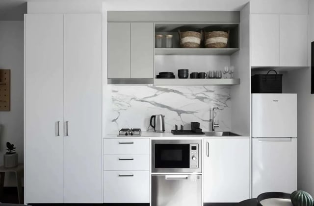 Studio apartment kitchen with modern appliances and cabinetry kitchen at UKO Paddington Village in Sydney Student Accommodation