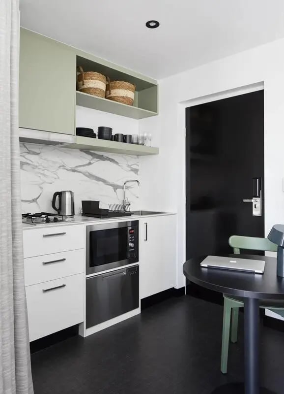Kitchenette with microwave stove sink and table kitchen at UKO Paddington Village in Sydney Student Accommodation