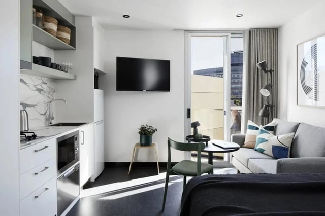 Modern studio kitchen living room with sofa and TV at UKO Paddington Village in Sydney Student Accommodation