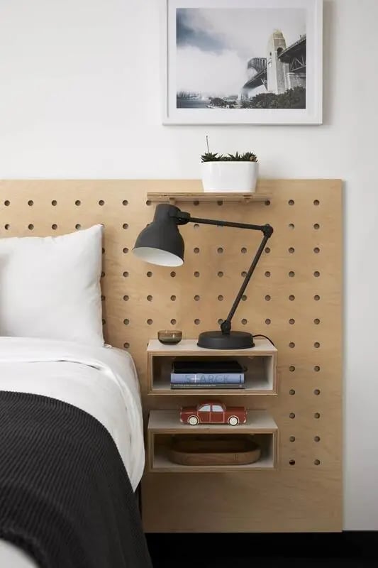 Bedside lamp plant books car wooden bowl bedroom at UKO Paddington Village in Sydney Student Accommodation