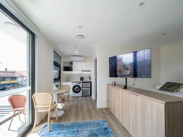 Kitchen dining area bed and TV studio apartment at UKO Annandale in Sydney Student Accommodation