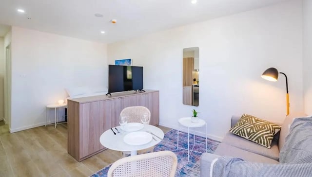 TV cabinet table chairs sofa rug living room at UKO Annandale in Sydney Student Accommodation