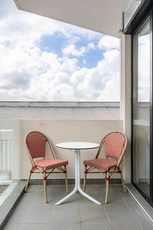 Chairs and table on balcony overlooking sky exterior at UKO Annandale in Sydney Student Accommodation