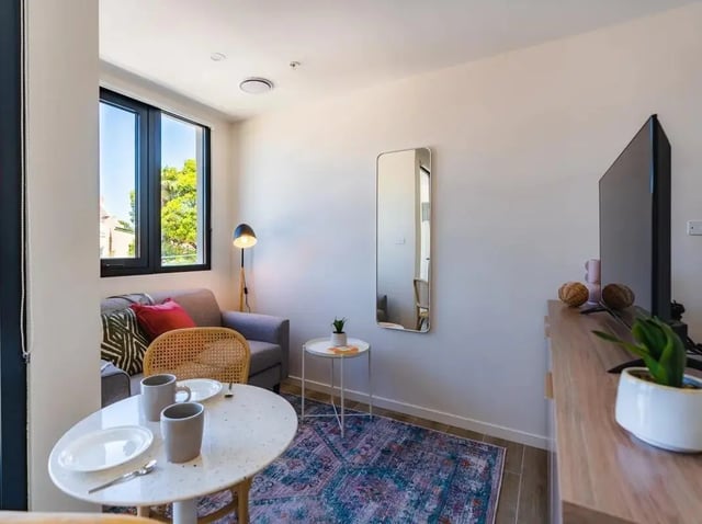 Sofa table mirror and TV living room at UKO Annandale in Sydney Student Accommodation