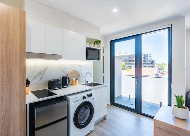 Modern kitchenette with fridge washer sink kitchen living room at UKO Annandale in Sydney Student Accommodation