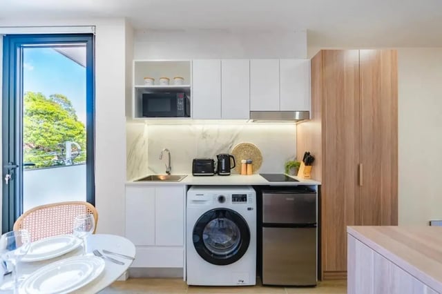 Compact kitchen with appliances and dining table kitchen at UKO Annandale in Sydney Student Accommodation