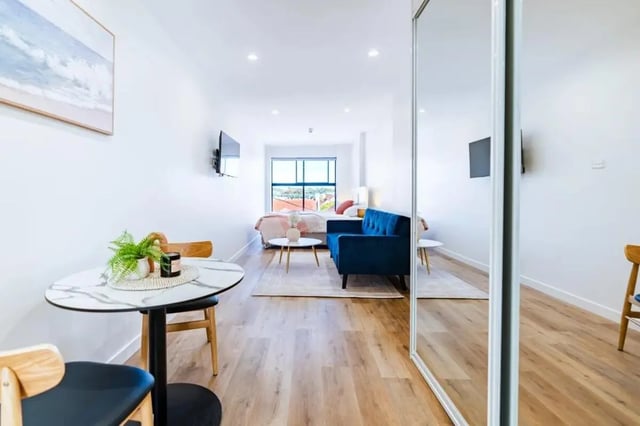 Blue sofa bed and table living room at UKO Annandale Tower C in Sydney Student Accommodation