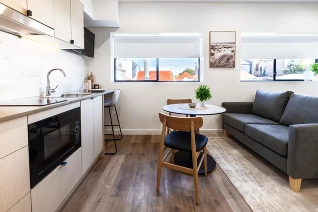 Kitchen sofa dining table and chairs living area at UKO Annandale Tower C in Sydney Student Accommodation