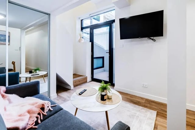 Sofa mirror table TV glass door living room at UKO Annandale Tower C in Sydney Student Accommodation