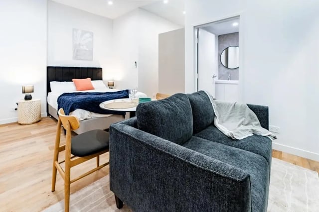 Sofa bed and table with chair Living area at UKO Annandale Tower C in Sydney Student Accommodation