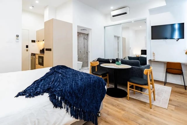 Bed kitchen sofa dining table bathroom exterior at UKO Annandale Tower C in Sydney Student Accommodation