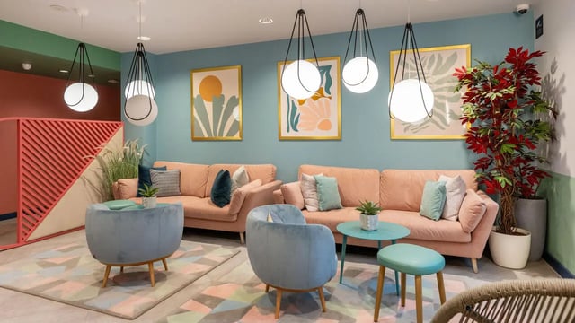 Pink sofas blue armchairs artwork living room at Wick Park in London Student Accommodation