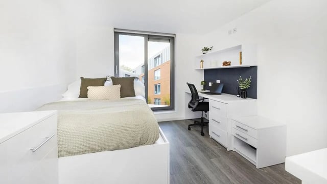 Bed desk chair and laptop bedroom study area at The Cube Ealing in London Student Accommodation