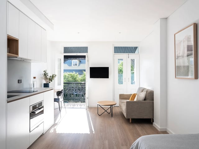 Modern kitchen living room with sofa and table at UKO Glebe in Sydney Student Accommodation