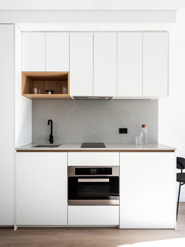 White cabinets sink oven and wooden shelf kitchen at UKO Glebe in Sydney Student Accommodation