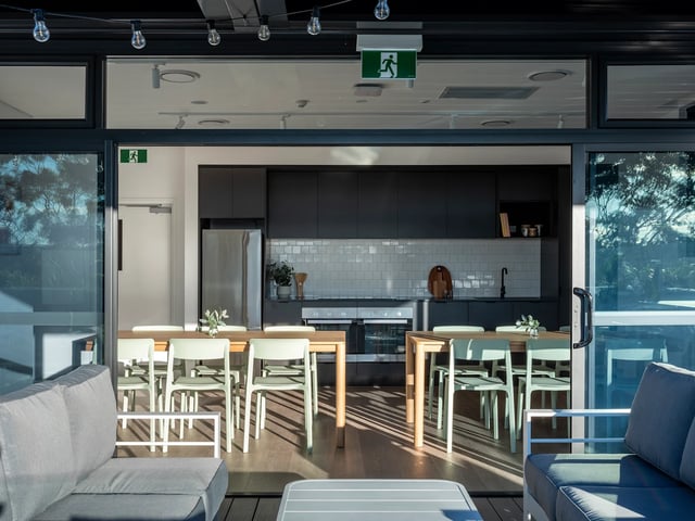 Dining table and chairs kitchen area living room exterior at UKO Glebe in Sydney Student Accommodation