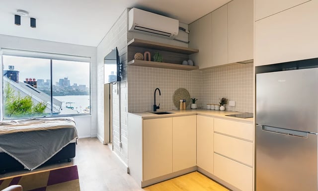 Bed fridge and kitchen cabinets studio apartment at UKO Balmain in Sydney Student Accommodation