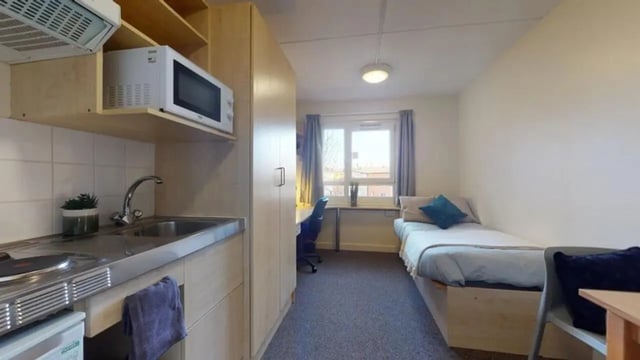 Kitchenette, bed, desk, and chair student studio at Creek Court in London Student Accommodation