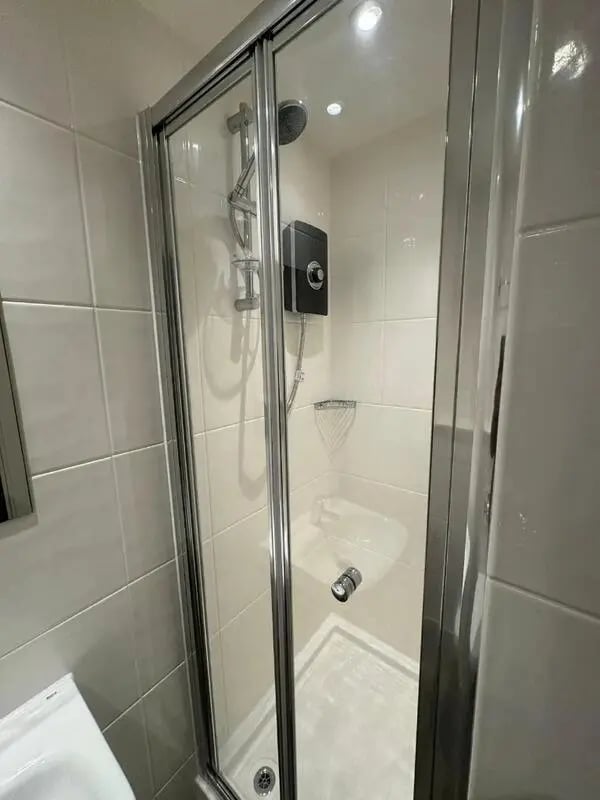Glass shower enclosure with showerhead and controls bathroom at Cleveland Apartments in Wolverhampton Student Accommodation