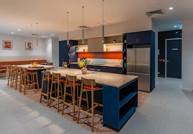 Kitchen island with bar stools and appliances kitchen at UKO Melbourne Central in Melbourne Student Accommodation