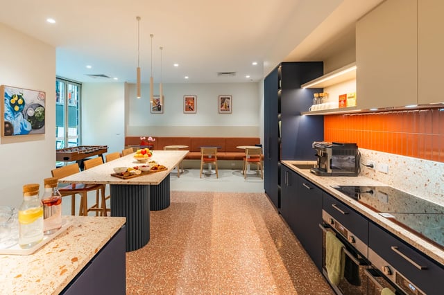 Foosball table table benches and kitchen communal area at UKO Melbourne Central in Melbourne Student Accommodation