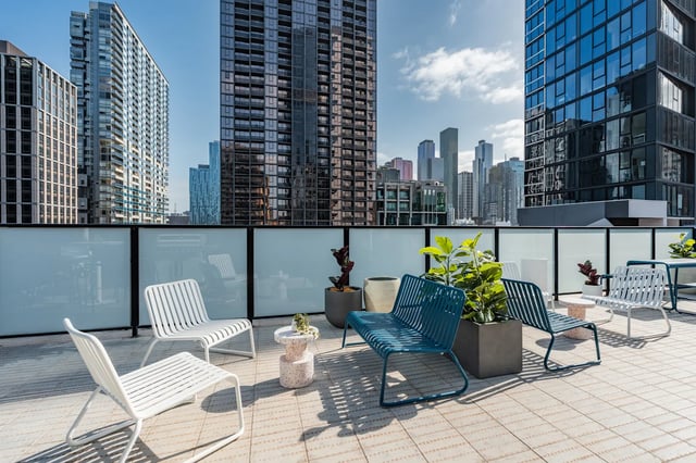 Chairs planters tables and cityscape view exterior at UKO Melbourne Central in Melbourne Student Accommodation