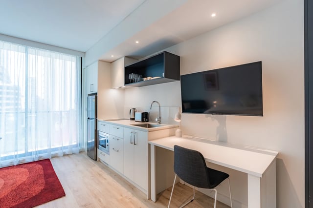 Kitchenette with desk and TV area at UKO Melbourne Central in Melbourne Student Accommodation