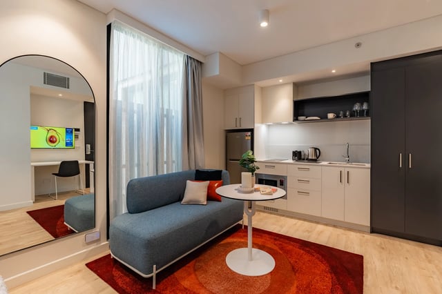 Sofa kitchen and study area studio apartment at UKO Melbourne Central in Melbourne Student Accommodation