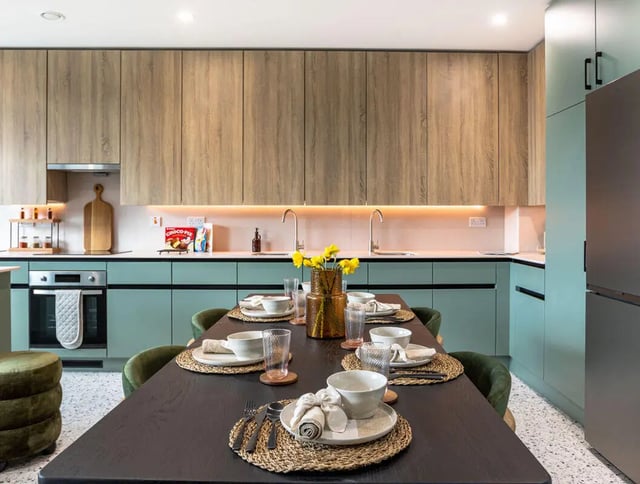 Dining table chairs vases and kitchen area kitchen at Yugo Haüs in Birmingham Student Accommodation
