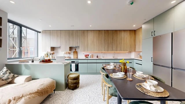 Sofa island dining table kitchen appliances kitchen dining area at Yugo Haüs in Birmingham Student Accommodation