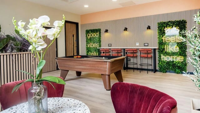 Pool table bar stools neon signs lounge area at Fontenoy Apartments in Liverpool Student Accommodation