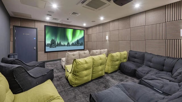Beanbag chairs and sofas facing screen cinema room at 26 Great George Street in Leeds Student Accommodation