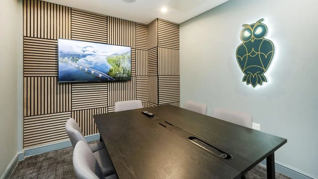 Dark table chairs and owl decor meeting room at 26 Great George Street in Leeds Student Accommodation