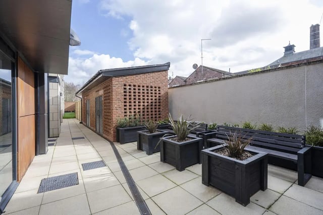 Paved courtyard with benches and planters exterior at Waterloo House in York Student Accommodation