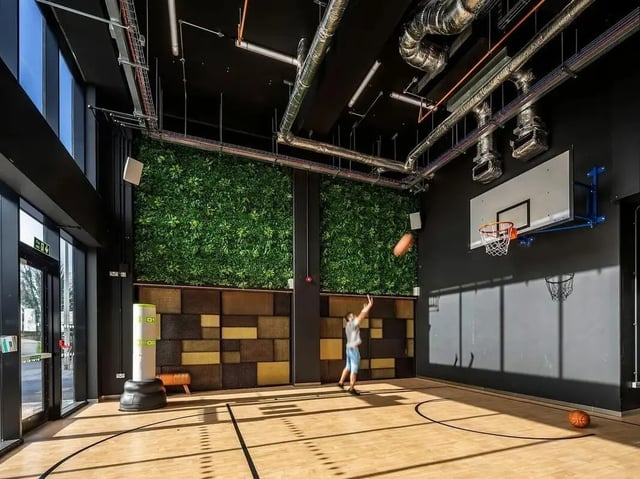 Student plays basketball in modern recreational space at Zenith in Cardiff Student Accommodation