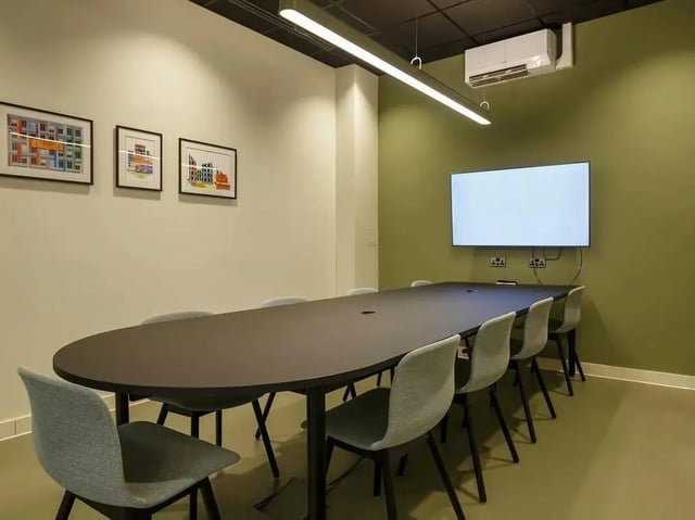 Large table with chairs and TV meeting room at COSMOS in Sheffield Student Accommodation