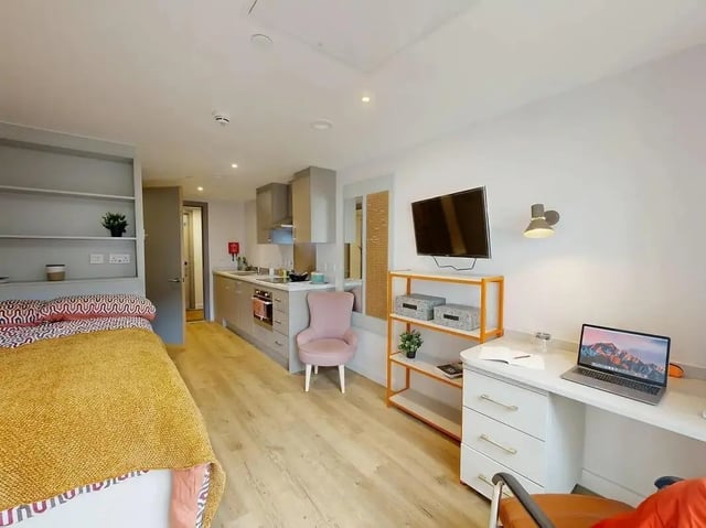 Bed kitchen study desk with laptop student accommodation living room at COSMOS in Sheffield Student Accommodation