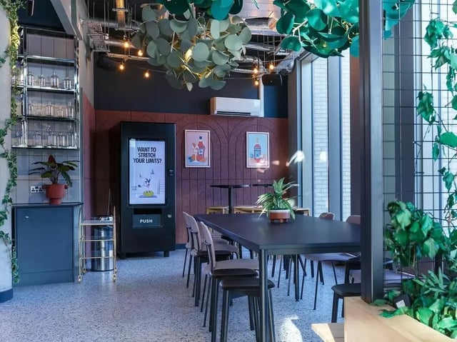 Vending machine table chairs and shelving communal area at COSMOS in Sheffield Student Accommodation