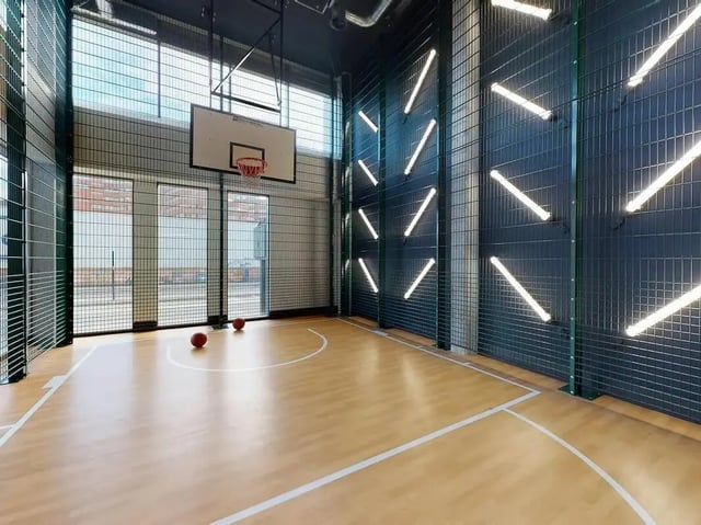 Basketball court with hoop and balls playing area at COSMOS in Sheffield Student Accommodation