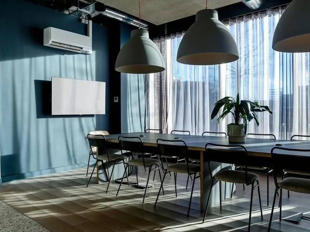 Table chairs air conditioner screen meeting room at COSMOS in Sheffield Student Accommodation