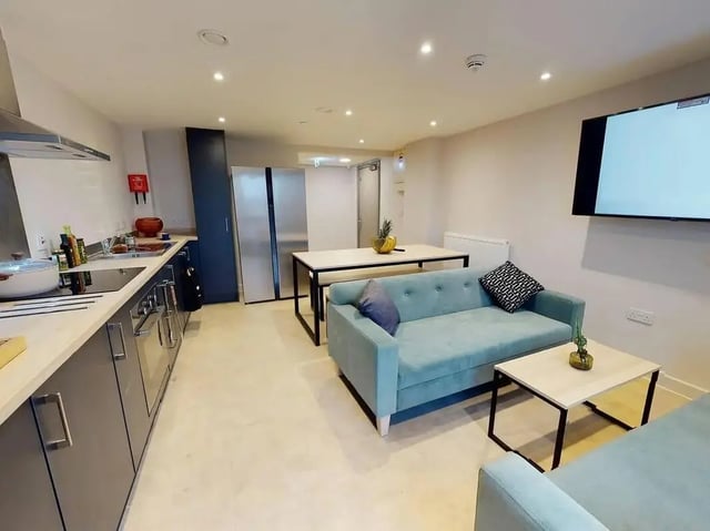 Kitchen with sofa dining table and TV lounge at COSMOS in Sheffield Student Accommodation
