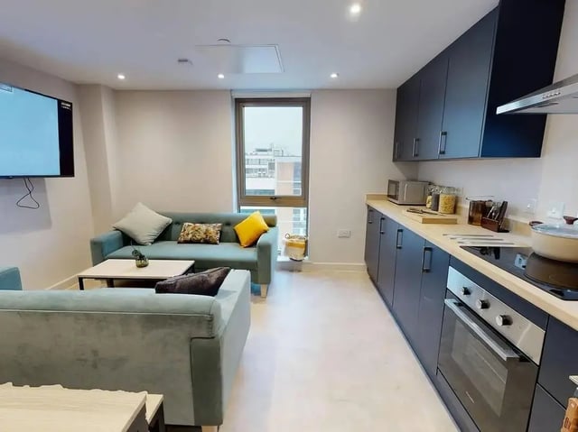 Modern living kitchen with sofas and cabinets living room at COSMOS in Sheffield Student Accommodation