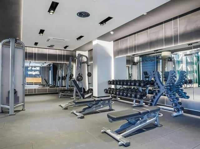Dumbbells weight benches and gym equipment workout area at COSMOS in Sheffield Student Accommodation