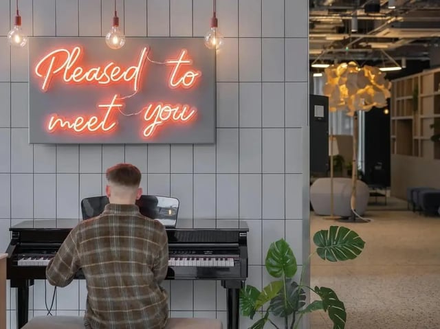 Neon sign and piano with student common area at COSMOS in Sheffield Student Accommodation