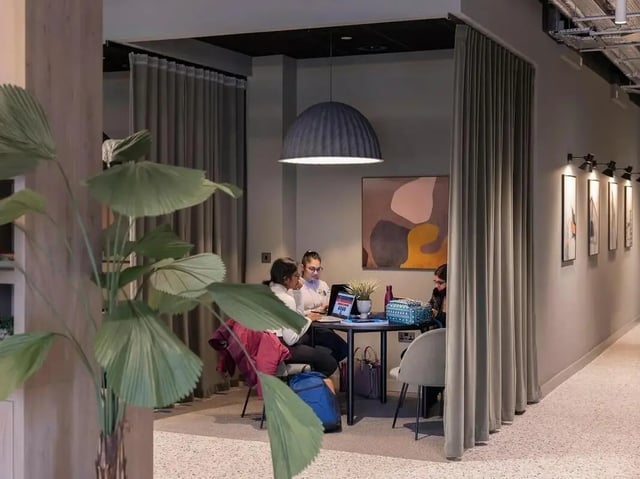 Students studying at desk with laptops study area at COSMOS in Sheffield Student Accommodation