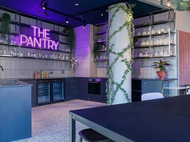 Neon sign shelves and kitchen counter kitchen at COSMOS in Sheffield Student Accommodation